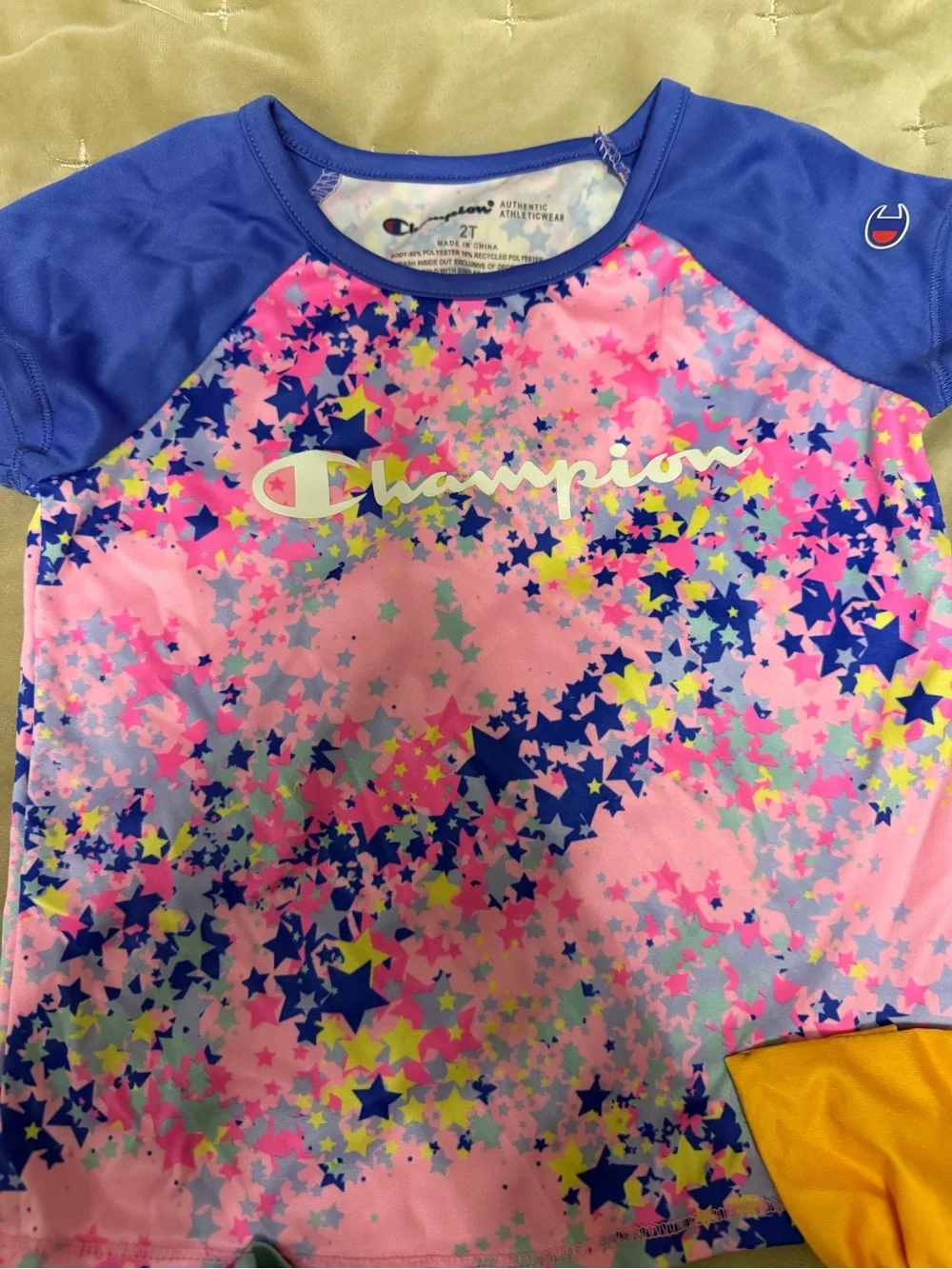 Champion Kids Swim Shirt with two bikinis featuring unicorns and flowers
